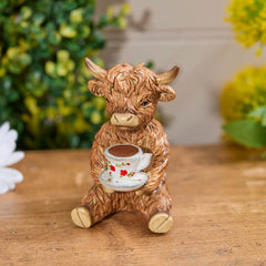 Highland cow with teacup