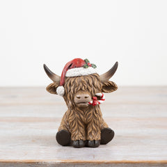 Festive Highland Cow with candy cane